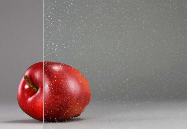A red apple sitting on top of a table.