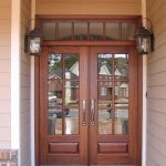 A pair of wooden doors with glass panes on the outside.