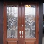 A pair of doors with glass panels and wood trim.