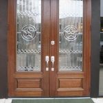 A pair of doors with glass panels and star designs.