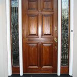 A door with two side panels and one with glass.