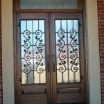 A double door with wrought iron design on the side.