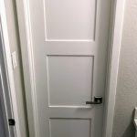 A door with two panels and one of the bottom panel is closed.